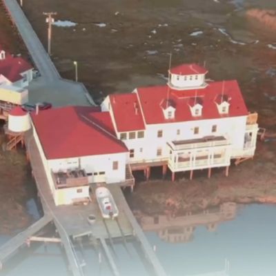 aerial shot of a building in a marshland